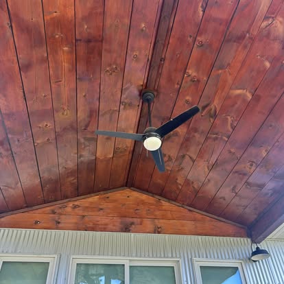 Tongue-and-groove porch ceiling stained in warm cedar