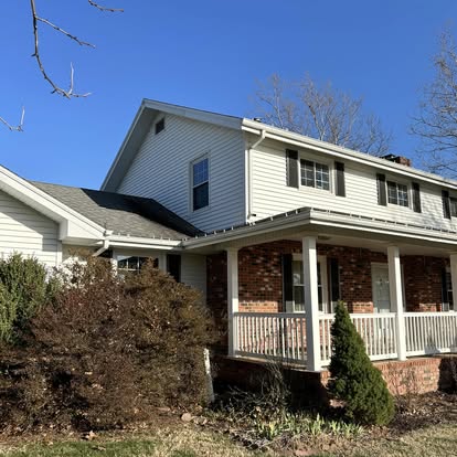 Brick and siding home with porch after a full wash