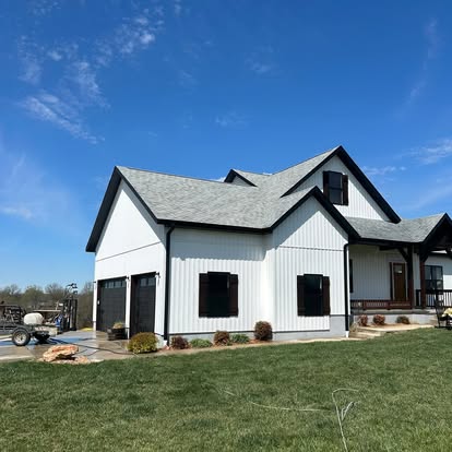 Two-story home with bright clean siding after pressure washing
