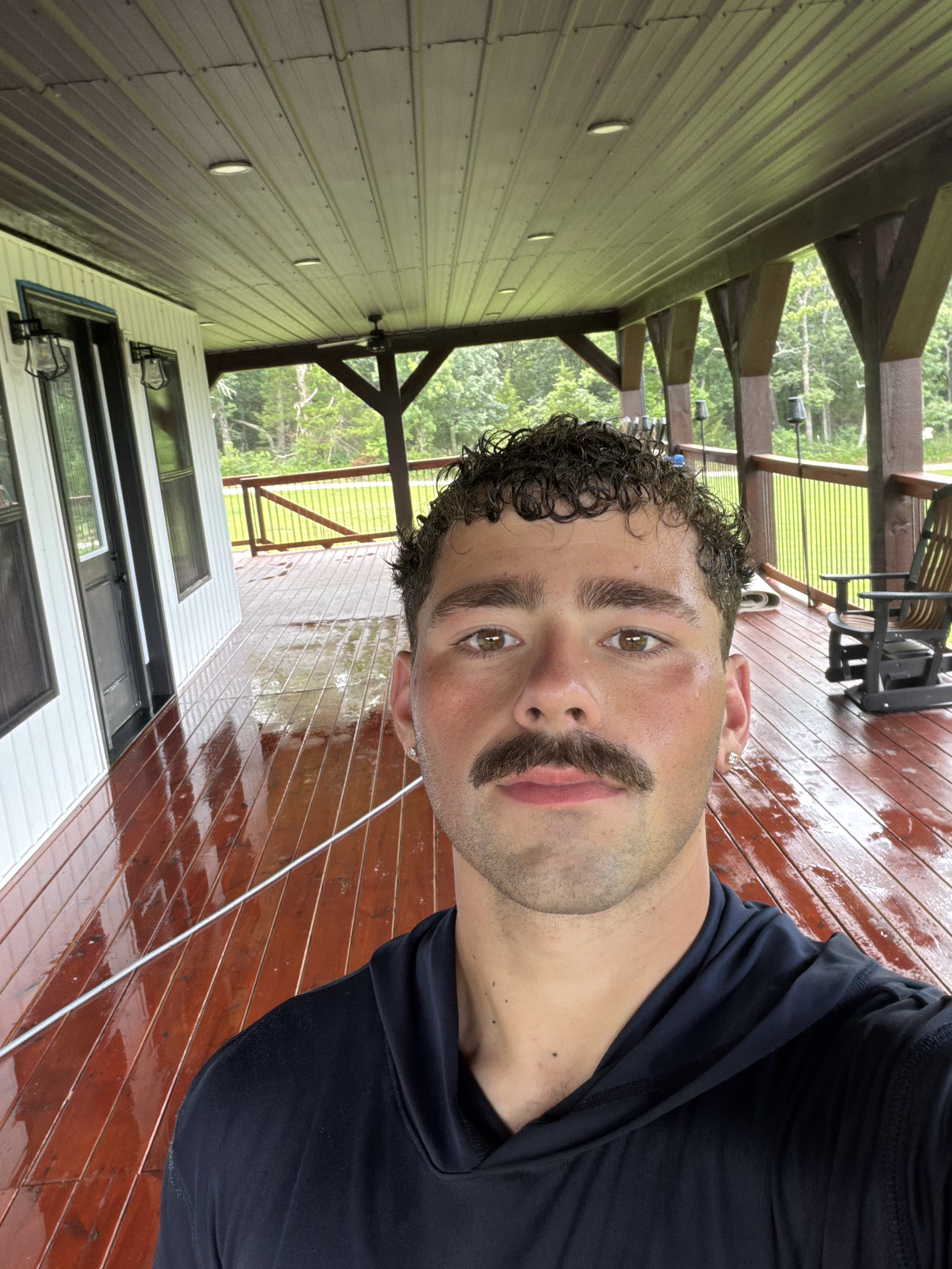 A.J. Tabor, owner, standing on a freshly stained deck